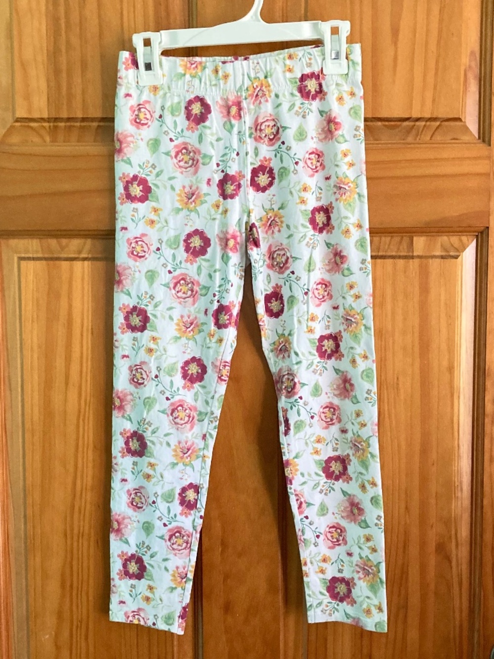 Girl’s size 7-8 white leggings with pink yellow and green floral pattern